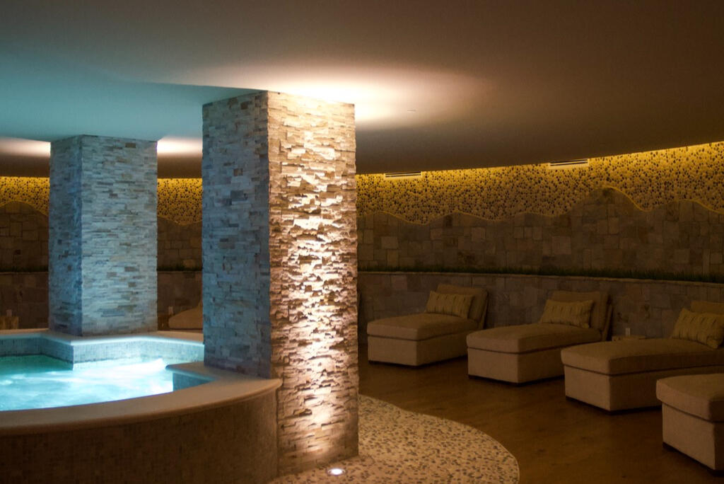 The Spa got a warm reverse cove and pillars up-lit to graze the texture.