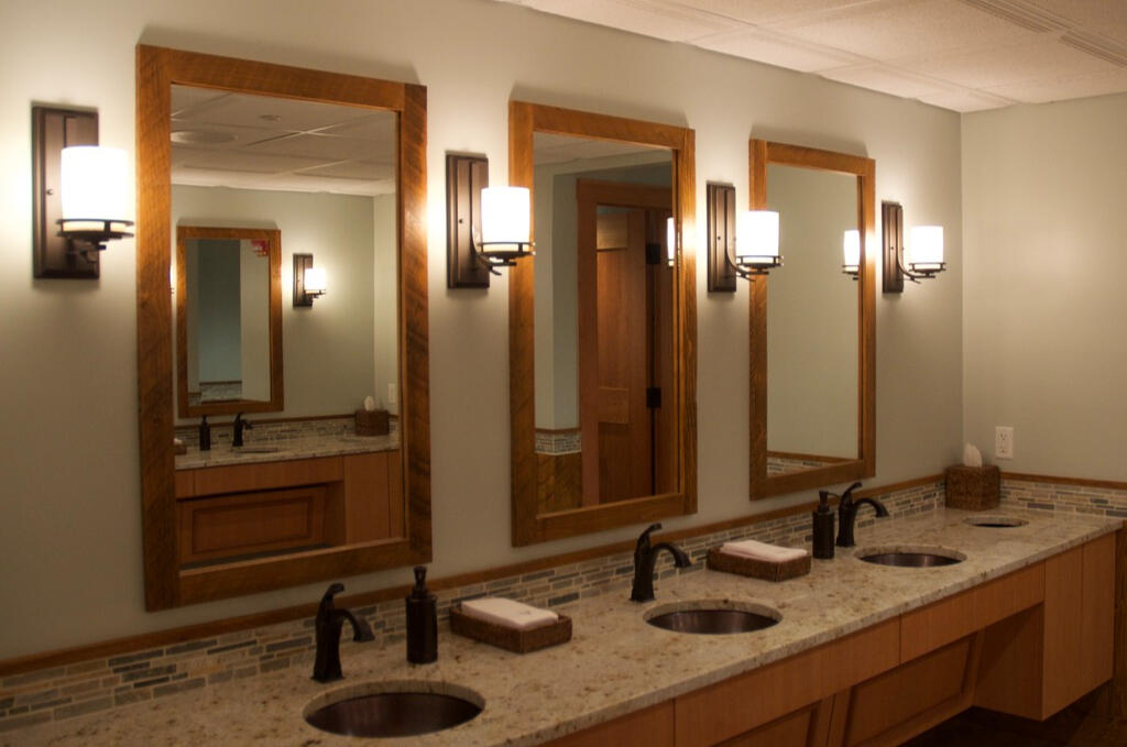 Restrooms lit with sconces.