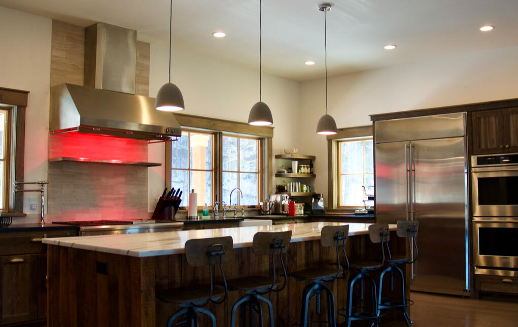 A dream to cook in! Concrete pendants over the island & infra-red warming lights in the hood, plus double ovens and a large capacity R/F.
