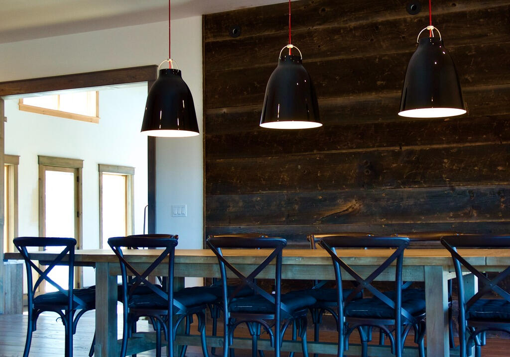 The long dining table gets lit with a trio of large Carravagio pendants, designed by award-winning Danish designer Cecilie Manz.